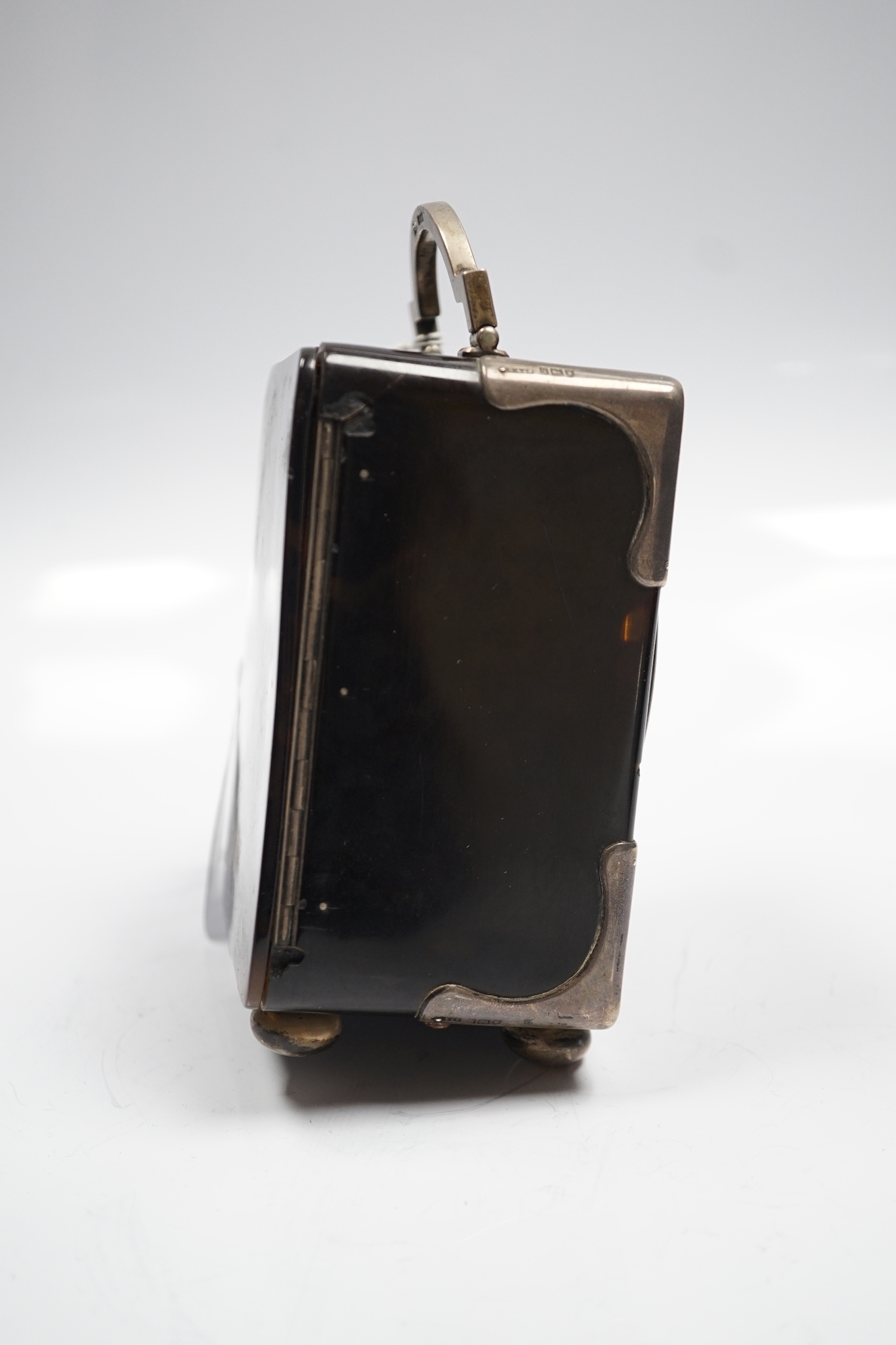 A George V silver mounted tortoiseshell cased carriage clock, with Arabic dial, chips to the case and ball foot missing, height 15cm over handle.
